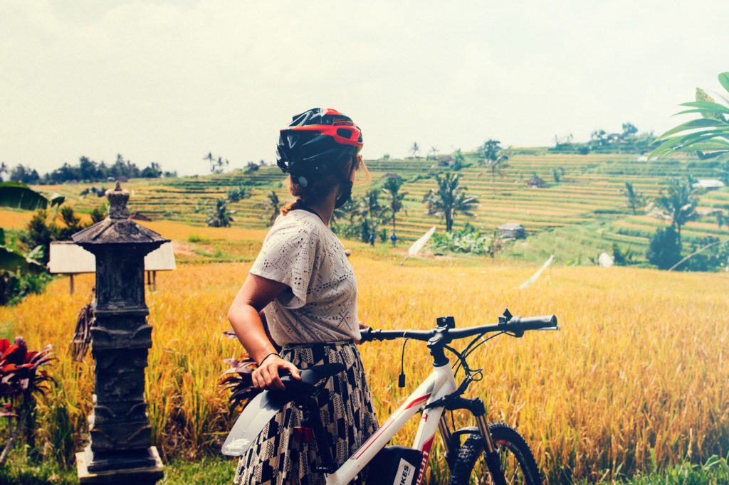 Ebike tour posing in front of yellow rice fields in Jatiluwih